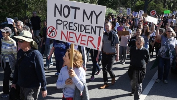 A woman holds a sign during a protest against President-elect Donald Trump at Golden Gate Park in San Francisco, November 2016.