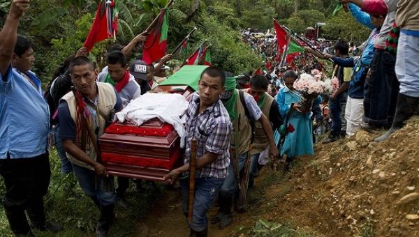 Hundreds of Indigenous people accompany the coffin of Daniel Coicue, a member of the Indigenous Nasa tribe.
