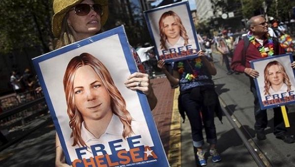 People hold signs calling for the release of imprisoned whistleblower Chelsea Manning in San Francisco, California June 28, 2015.