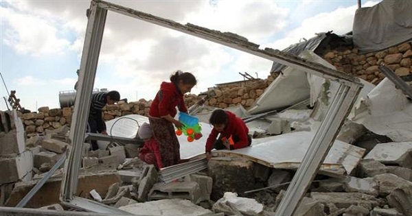 Palestinian children search for toys in the remains of their home demolished by Israeli forces, Feb 2. 2016