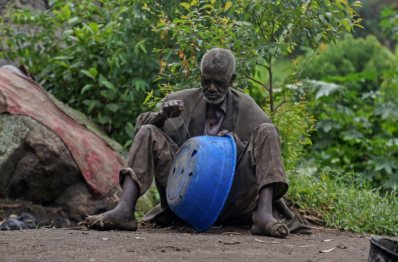 Kavuha, 73, repairs a container at Kagorwa Pygmy camp on Idjwi island. Around 1980, the Bambuti say, local authorities and customary chiefs from the Bahavu, a Bantu people, expelled them from the forests and turned the land over to Bahavu to farm and build houses.