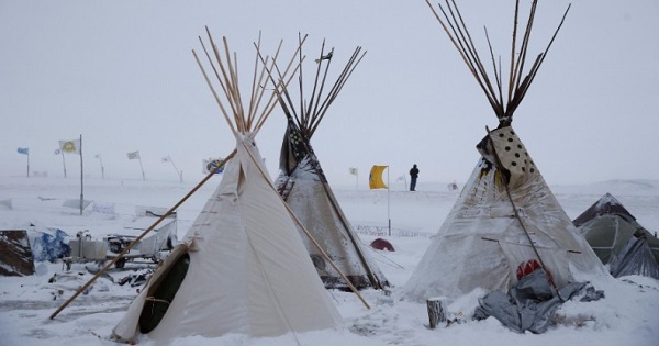 Teepees dusted in snow at the Oceti Sakowin camp.