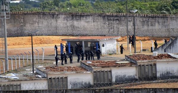 Police patrol the Alcazuz prison, in the Brazilian city of Natal, after a riot left at least 10 inmates dead.