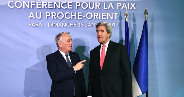 French Foreign Minister Jean-Marc Ayrault welcomes U.S. Secretary of State John Kerry as he arrives for the peace conference in Paris, France, Jan. 15, 2017.