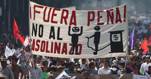 Protesters march during a demonstration in downtown Mexico City against the rising prices of gasoline implemented by the Mexican government.