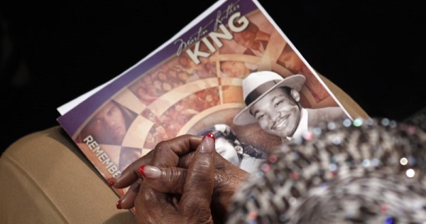 A visitor holds a commemorative booklet as she listens during the Martin Luther King, Jr. service at Ebenezer Baptist Church in Atlanta, Georgia, Jan. 20, 2014.