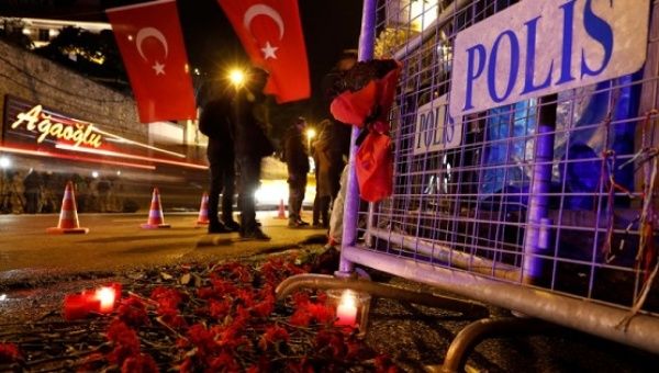 Flowers are placed in front of a police barrier near the entrance of Reina nightclub in Istanbul, Turkey, which was attacked by a gunman.