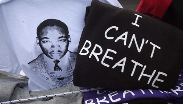 T-shirt of MLK next to one recalling the murder of Eric Garner who was strangled to death by the NYPD.