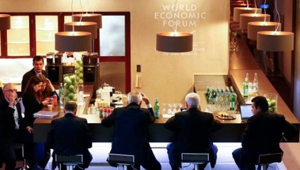 Participants sit at a bar during the annual meeting of the World Economic Forum in Davos, Switzerland Jan. 21, 2016.