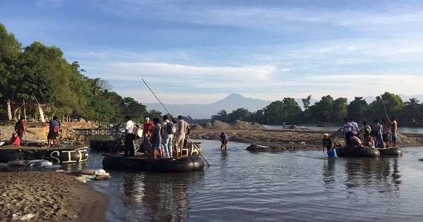Refugees and local traders use rafts to cross the Suchiate River that divides Guatemala and Mexico. Dec. 12, 2016.