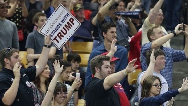 Donald Trump supporters at a campaign rally in Orlando, Florida, raising their arms to show support for him, March 5, 2016.