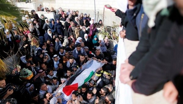 Mourners carry the body of Palestinian youth Qusai Amour during his funeral in the West Bank village of Tuqu near Bethlehem.