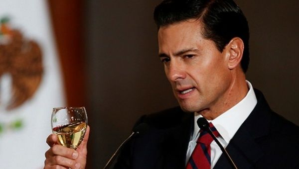 Mexico's President Enrique Pena Nieto makes a toast during a meeting with members of the diplomatic corps in Mexico City, Mexico Jan. 11, 2017.