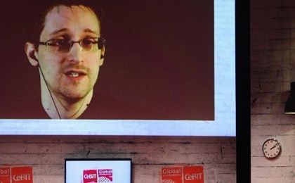 Edward Snowden is seen on the screen during a live remote interview at CeBIT 2015, the world's top trade fair for information and communication technology, in Hanover, Germany.