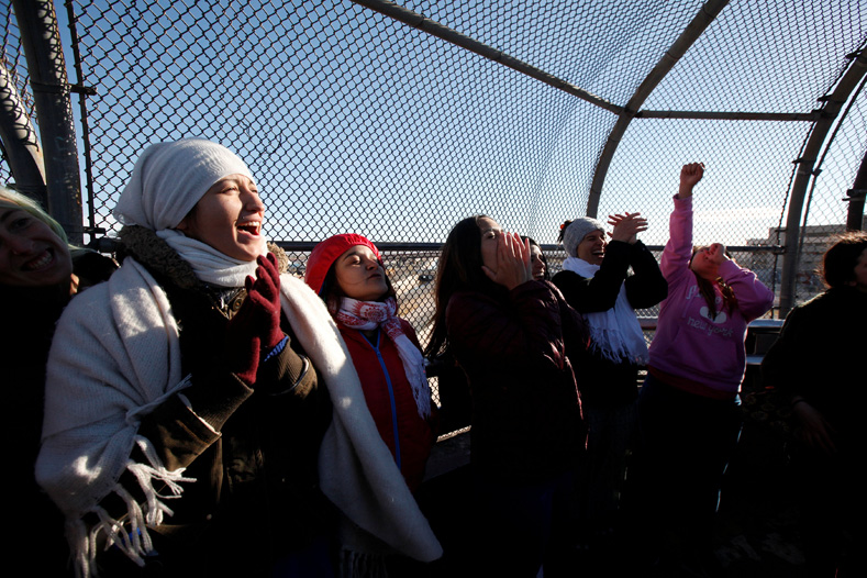 Women of the Boundless Across Borders organization react during a bi-national protest called Braiding Borders at the Santa Fe international crossing bridge to send a message to U.S. President-elect Donald Trump that women's rights are human rights, in Ciudad Juarez, Mexico, Jan. 20, 2017. 