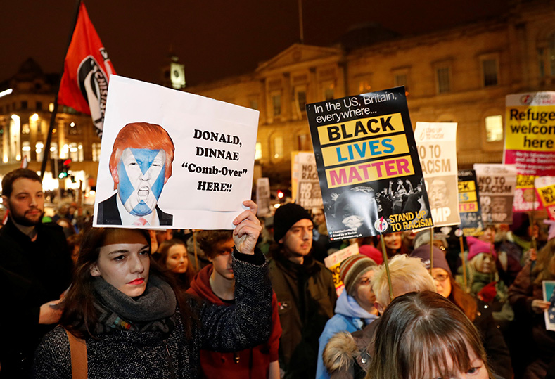 Demonstrators hold up banners during a protest against the inauguration of Donald Trump as U.S. President in Edinburgh, Scotland, Jan. 20, 2017.