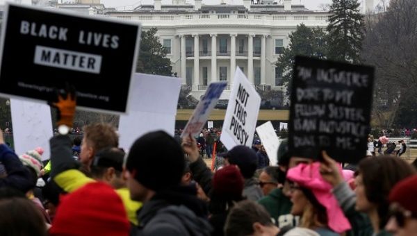 People pass the White House as they march in the Women’s March on Washington in reaction to U.S. President Donald Trump's inauguration.