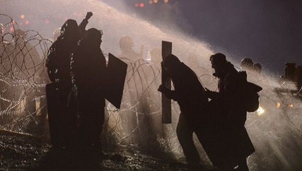 Police use a water cannon on Standing Rock protesters last November.