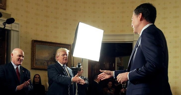 President Trump greets Director of the FBI James Comey as Director of the Secret Service Joseph Clancy (L) watches.