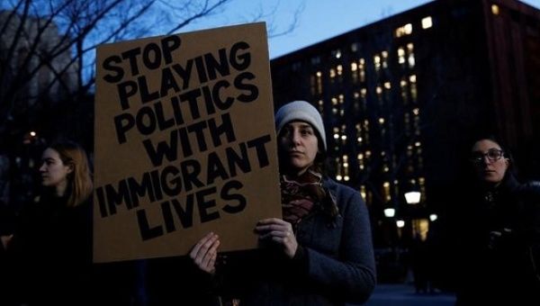 Danielle Frank holds a sign as demonstrators gather at Washington Square Park to protest against U.S. President Donald Trump in New York, U.S., Jan. 25, 2017. 