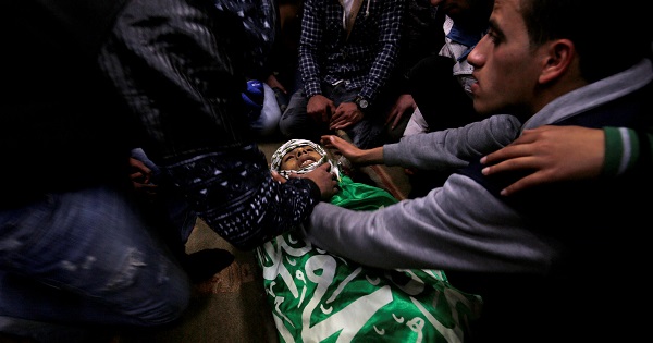 Mourners gather around the body of Palestinian Mohammed Abu Khalifa during his funeral in the Jenin refugee camp in the West Bank, Jan. 29, 2017.