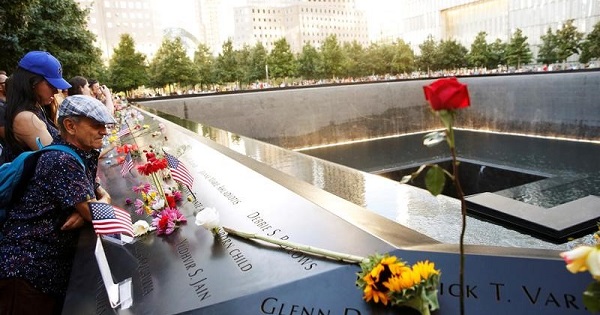 Visitors look out over the National September 11 Memorial and Museum on the 15th anniversary of the 9/11 attacks in Manhattan, New York, U.S.