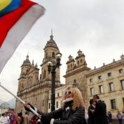 People demonstrate on the street as Colombia's President Juan Manuel Santos and Marxist FARC rebel leader Rodrigo Londono, known as Timochenko, sign a new peace accord in Bogota, Colombia, Nov. 24, 2016. 