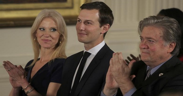 Senior staff at the White House Kellyanne Conway, Jared Kushner and Steve Bannon (L-R) applaud before being sworn in, Washington, Jan. 22, 2017.