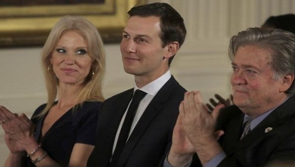Senior staff at the White House Kellyanne Conway, Jared Kushner and Steve Bannon (L-R) applaud before being sworn in, Washington, Jan. 22, 2017. 