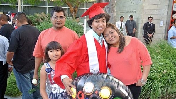 Miguel Molina at his high school graduation with his parents and sister.
