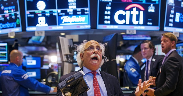 Trader Peter Tuchman gestures as he talks on the phone following the resumption of trading on the floor of the New York Stock Exchange in New York, U.S.