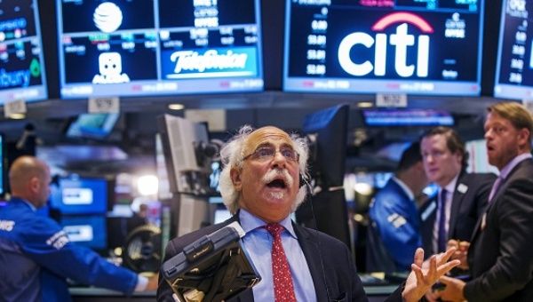Trader Peter Tuchman gestures as he talks on the phone following the resumption of trading on the floor of the New York Stock Exchange in New York, U.S.