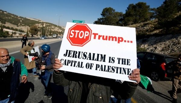 Palestinian demonstrator holds placard during a protest against a promise by U.S. President-elect Donald Trump to re-locate U.S. embassy to Jerusalem.