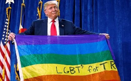 Donald Trump holds up a rainbow flag with 
