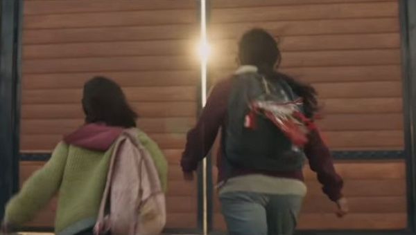 In the commercial, the mother and daughter find a gate in the border wall that they can open. 