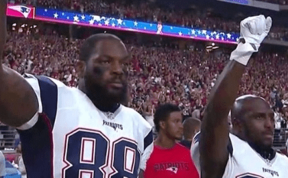 New England Patriots Martellus Bennett (L) and Devin McCourty (R) raise fists in protest during the U.S. national anthem, Sept. 11, 2016.