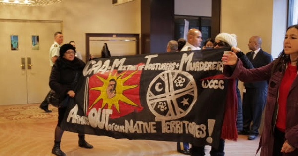 Activists disrupt the Conference of American Armies in a downtown Toronto hotel.