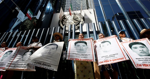 Relatives hold posters with images of some of the 43 missing students outside the Attorney General's Office in Mexico City, Mexico, Feb. 9, 2017.