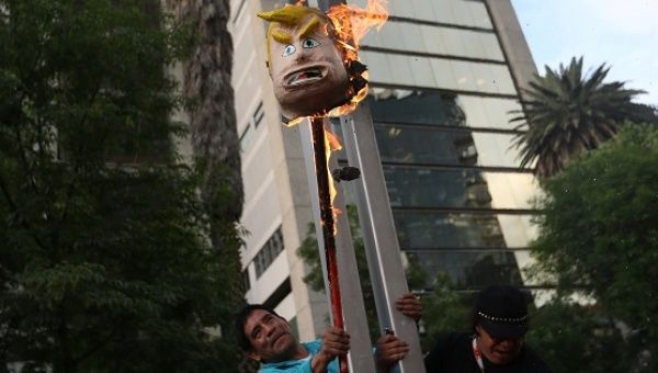 Demonstrators burn a pinata representing the U.S. President Donald Trump during a protest outside the U.S. embassy, in Mexico City, Mexico, Jan. 20, 2017