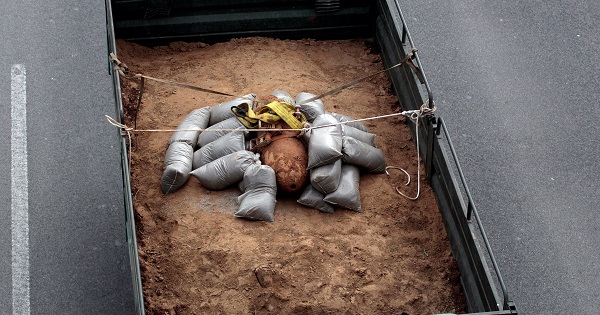 A 250 kg World War Two bomb that was found during excavation works at a gas station, is carried on a military truck.