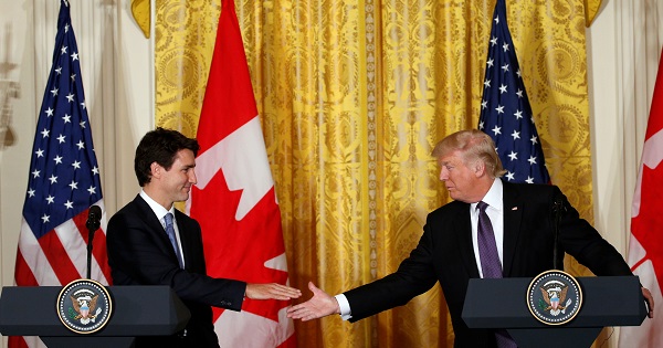 Canadian PM Trudeau and U.S. President Trump shake hands during a joint news conference at the White House in Washington.