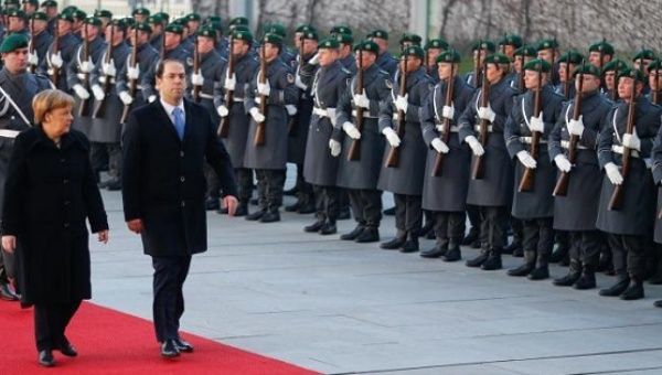 German Chancellor Angela Merkel and Tunisian Prime Minister Youssef Chahed review the guard of honour at the Chancellery in Berlin, Germany.
