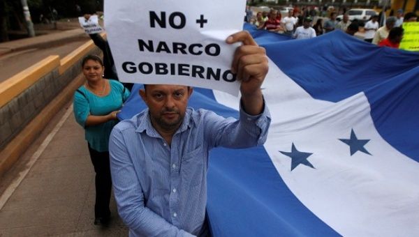 Demonstrators march against the re-election bid of Honduras President Juan Orlando Hernandez.