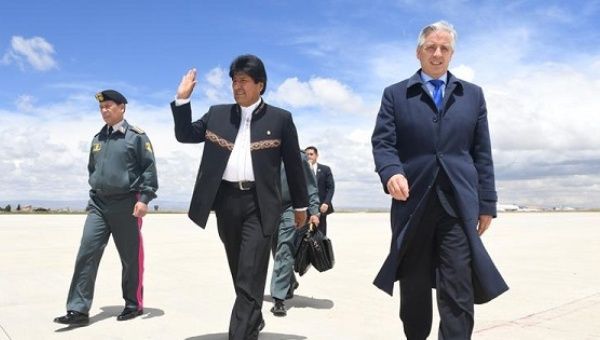 Evo Morales walks with Vice President Alvaro Garcia Linera as he prepares to fly to The Hague, Feb. 13, 2017.