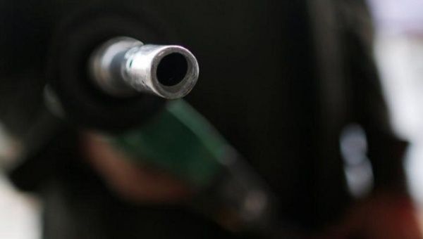 A man points a nozzle at the camera at a Pemex petrol station in Mexico City, Mexico, Feb. 3, 2017.