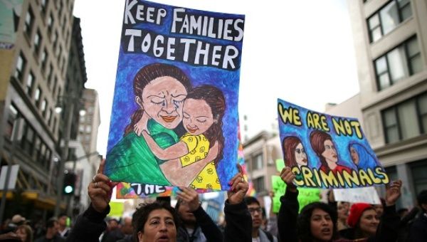 People participate in a protest march calling for human rights and dignity for immigrants, in Los Angeles, Feb. 18, 2017. 