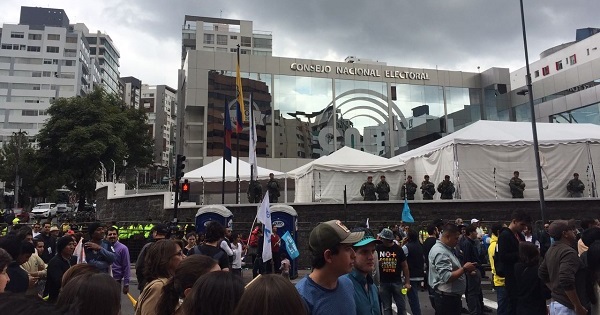 Protesters gather outside the National Electoral Council in Quito.