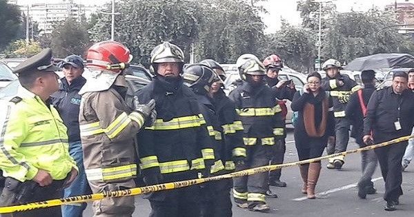 Firefighters gather outside of the Alianza Pais headquarters in Quito, Ecuador after receiving a bomb threat.
