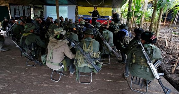 Members of FARC's 51st Front listen to a lecture on the peace process at a camp in Cordillera Oriental, Colombia, Aug. 16, 2016.