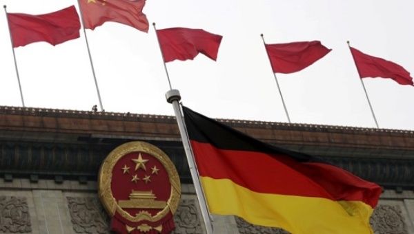 A German flag flutters in front of the Great Hall of the People in Beijing.
